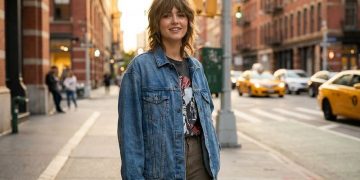 Woman with classic medium wolf cut choppy layers urban street style