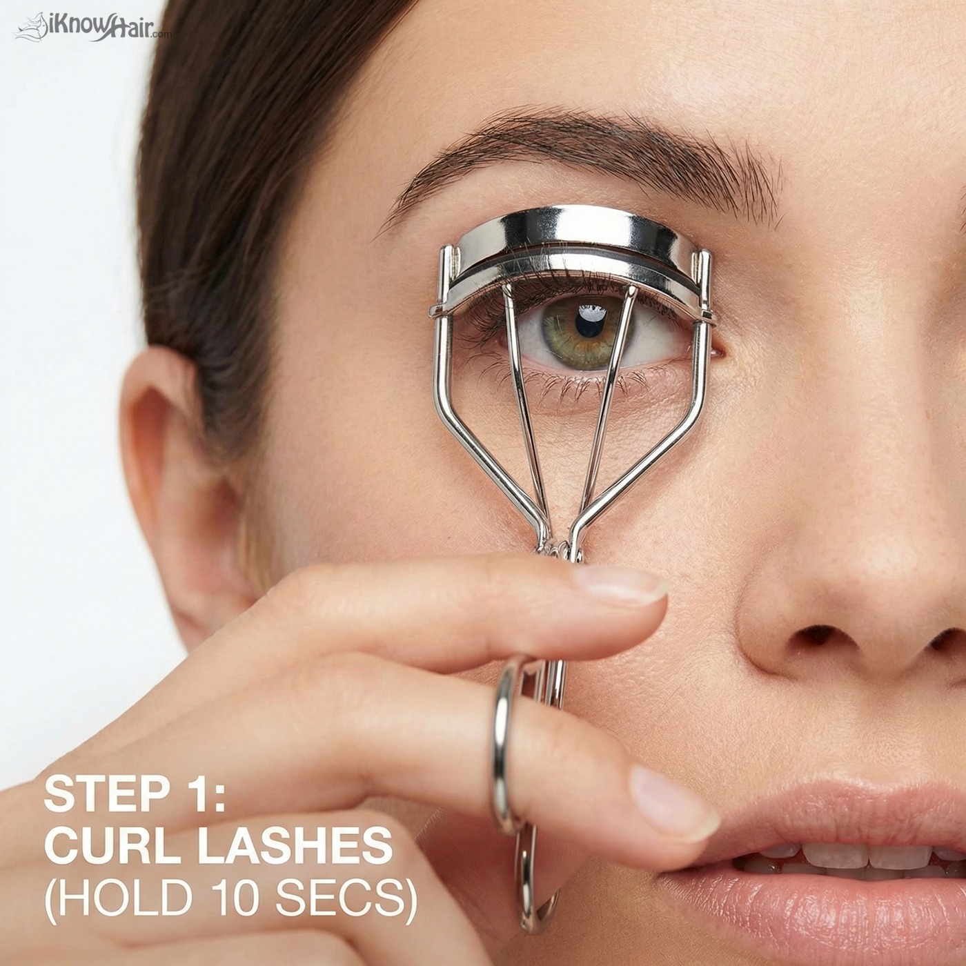 Woman using eyelash curler correctly