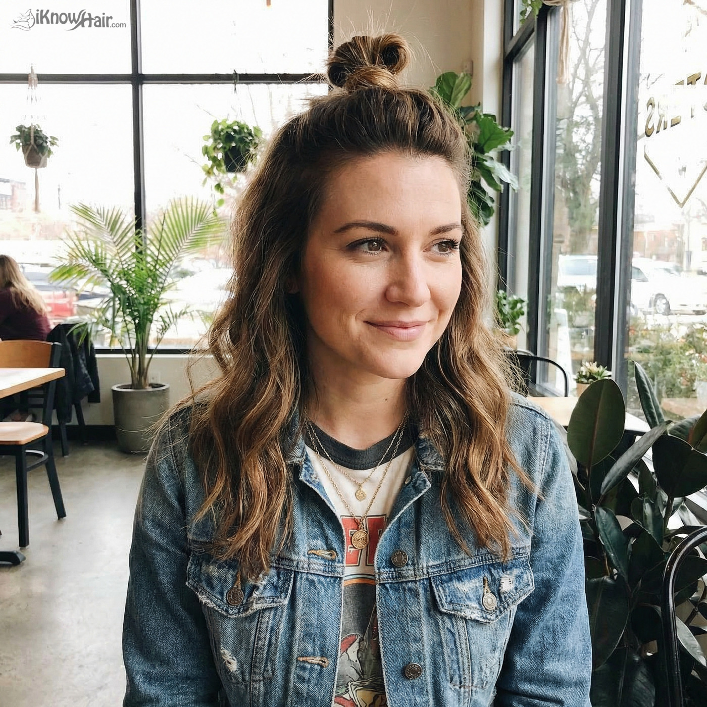 Woman with half up top knot style