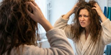 Woman fixing bad hair day with quick styling hack